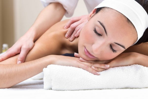 Pretty Woman enjoying shoulder massage at beauty spa